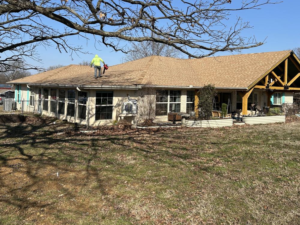 Tamko Titan Rustic Cedar shingle roof replacement in Checotah, Oklahoma, with a Diamond B Roofing crew member clearing the new roof
